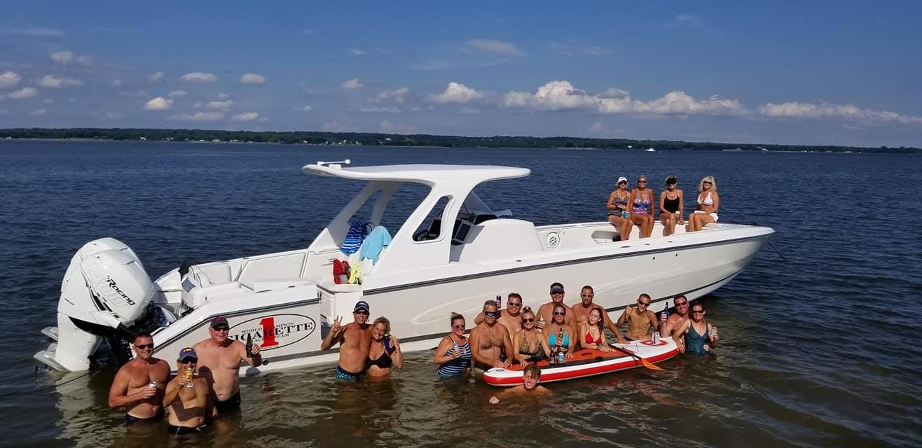 People Swimming By A Boat