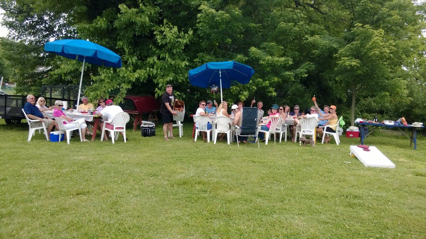 Group Of People Looking Back And Waving At Camera